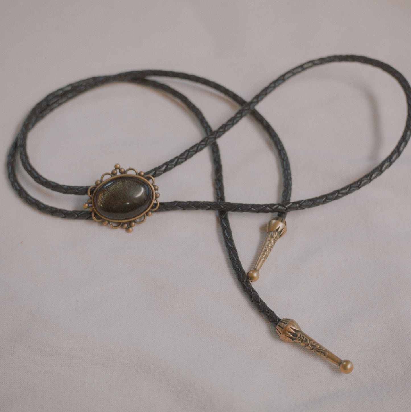 127 Golden Obsidian Bolo Tie - “Shadows of the Past”
